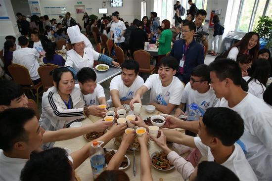 Children orphaned by the devastating earthquake and volunteers return to the Ankang Home to mark the 10th anniversary. The huge banner reads: "Ten years since Wenchuan earthquake, we have grown up."