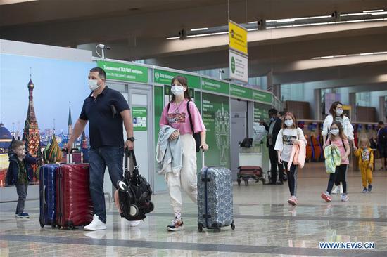 Passengers walk at the Sheremetyevo International Airport in Moscow, Russia, on Aug. 1, 2020. Russia has partially resumed its international flights starting Aug. 1, according to reports. (Photo by Alexander Zemlianichenko Jr/Xinhua)