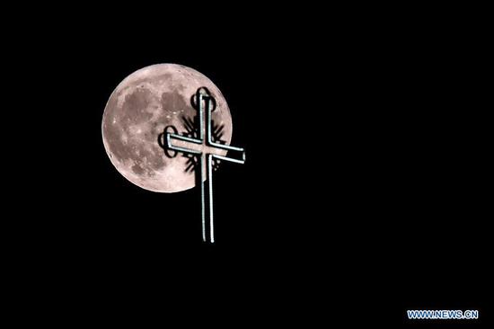 A full moon rises over a church in old town of Ohrid, North Macedonia, Aug. 3, 2020. (Photo by Tomislav Georgiev/Xinhua)