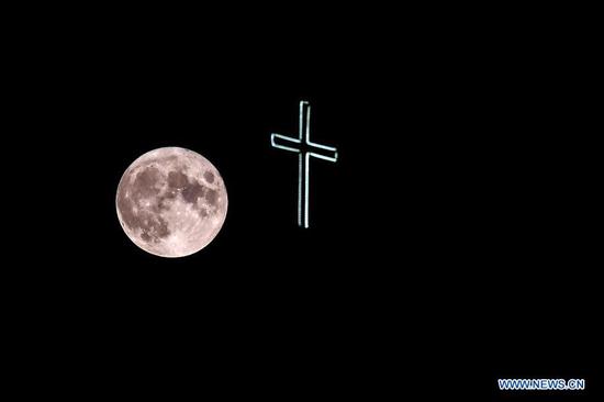 A full moon rises over a church in old town of Ohrid, North Macedonia, Aug. 3, 2020. (Photo by Tomislav Georgiev/Xinhua)