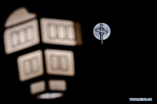 A full moon rises over a church in old town of Ohrid, North Macedonia, Aug. 3, 2020. (Photo by Tomislav Georgiev/Xinhua)