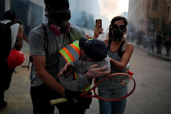 Demonstrators take part in anti-government protests that have been ignited by a massive explosion in Beirut, Lebanon on Monday.