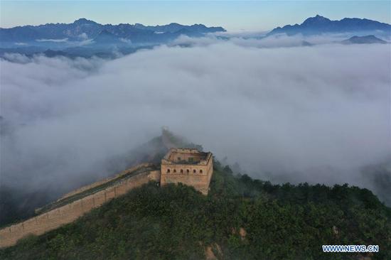 Aerial photo taken on Aug. 10, 2020 shows the Jinshanling Great Wall shrouded in morning mist in Luanping County of Chengde City, north China's Hebei Province. (Photo by Zhou Wanping/Xinhua)