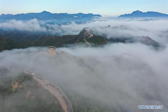 Aerial photo taken on Aug. 10, 2020 shows the Jinshanling Great Wall shrouded in morning mist in Luanping County of Chengde City, north China's Hebei Province. (Photo by Zhou Wanping/Xinhua)