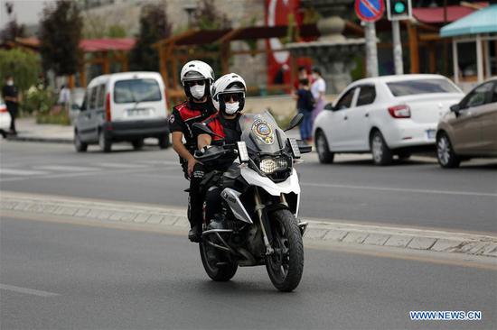 Policemen wearing face masks patrol on a street in Ankara, Turkey, on Aug. 11, 2020. Turkey confirmed 1,183 new COVID-19 cases on Tuesday, raising the total diagnosed cases to 243,180, Turkish Health Minister Fahrettin Koca said. (Photo by Mustafa Kaya/Xinhua)