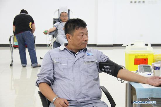 A staff member of Hengyi Industries Sdn Bhd has physical examination before participating in a blood donation in Bandar Seri Begawan, capital of Brunei, Aug. 13, 2020. Hengyi Industries Sdn Bhd, a China-Brunei petrochemical joint venture, held a blood donation drive on Wednesday and Thursday in collaboration with Brunei's Jerudong Park Medical Center, with the participation of over 60 Hengyi staff and management. (Xinhua)