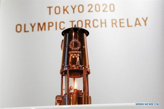 Japanese Olympic Committee President Yasuhiro Yamashita (R) receives the Olympic Flame from the Tokyo 2020 President Yoshiro Mori during the display ceremony at the Japan Olympic Museum in Tokyo, Japan on Aug. 31, 2020. The Tokyo Olympic flame, which had been kept in a secret place since the Games was postponed, has been put on display at the Japan Olympic Museum on Monday. A simple ceremony was held by Tokyo 2020 organizers and the Japanese Olympic Committee (JOC) to mark the opening of the public display, which will run from September 1 to November 1. (Xinhua/Pool/Rodrigo Reyes Marin)