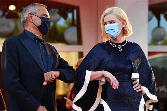 Director of the 77th Venice Film Festival Alberto Barbera (left), and Festival Jury President actress Cate Blanchett make elbow bump as they arrive at the Lido island for the opening ceremony and the screening of the film “Lacci” on Wednesday.