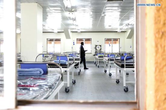 A man is seen inside a treatment center for COVID-19 patients at Namboole National Stadium in the central Ugandan district of Wakiso, about 15 km east of the capital Kampala, on Sept. 7, 2020. Uganda's ministry of health has converted parts of Namboole National Stadium into an auxiliary hospital to cater for the rapidly increasing number of COVID-19 cases in the east African country. (Photo by Hajarah Nalwadda/Xinhua)