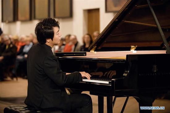 File photo taken in 2020 shows Chinese pianist Lang Lang performing Johann Sebastian Bach's Goldberg Variations at St. Thomas Church in Leipzig, Germany. Music is needed now more than ever, for it is a means of consolation for people enduring the plight caused by the coronavirus pandemic, world-renowned Chinese pianist Lang Lang said on Sept. 8, 2020 during a virtual dialogue with North America-based reporters to promote his newly released album featuring great German composer Johann Sebastian Bach's Goldberg Variations. Released on Sept. 4, Lang's new album is in cooperation with Deutsche Grammophon and contains two versions of the Goldberg Variations, one recorded in studio and the other a live performance in St. Thomas Church in Leipzig, Germany, where Bach was laid to rest. (Photo by Stefan Hoederath/Xinhua)