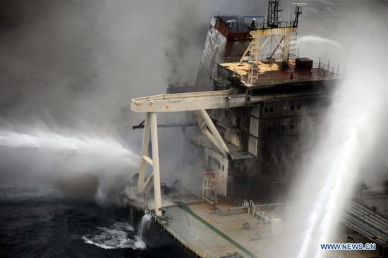 Fireboats extinguish fire of the MT New Diamond oil tanker in the seas off Sri Lanka's eastern coast, on Sept. 8, 2020. The Sri Lanka Navy on Wednesday said a fire which had reignited onboard the MT New Diamond oil tanker on Monday has been brought under control and the distressed ship was being towed further away towards safe waters by a tug boat. (Sri Lanka Air Force Media/Handout via Xinhua)