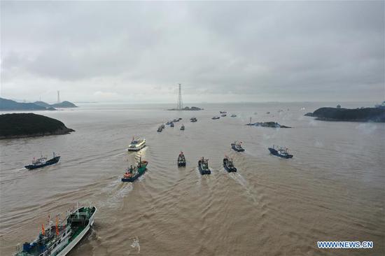 Aerial photo shows fishing boats sailing to the East China Sea in Zhoushan, east China's Zhejiang Province, Sept. 16, 2020. Fishing boats departed from ports in Zhejiang Province at noon on Wednesday, marking the end of the four-and-a-half month summer fishing ban in the East China Sea. (Photo by Zhang Lei/Xinhua)