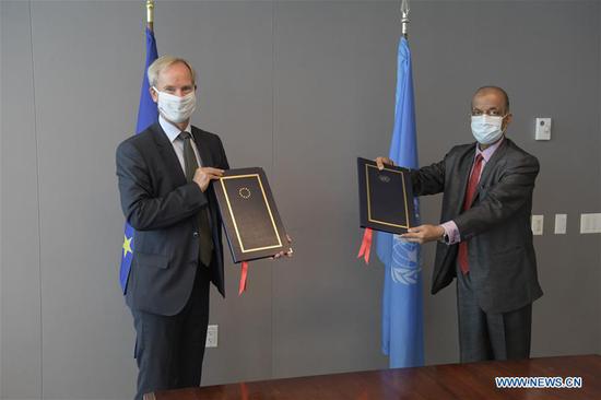 United Nations Undersecretary-General for Operational Support Atul Khare (R) and the head of EU Delegation to the United Nations Olof Skoog present the Framework Agreement Between the United Nations and the European Union for the Provision of Mutual Support in the context of their respective missions and operations in the field at the UN headquarters in New York, on Sept. 29, 2020. The United Nations and the European Union on Tuesday signed an agreement on the sidelines of the 75th session of the UN General Assembly to enhance cooperation and strengthen collective response in peace operations and crisis management. (Evan Schneider/UN Photo/Handout via Xinhua)