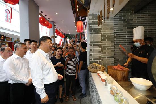 Chinese President Xi Jinping, also general secretary of the Communist Party of China Central Committee and chairman of the Central Military Commission, visits a street lined with ancient memorial archways to check the development of cultural and tourism resources in Chaozhou, south China's Guangdong Province, Oct. 12, 2020. Xi on Monday arrived in Guangdong to begin an inspection tour of the province. (Xinhua/Ju Peng)