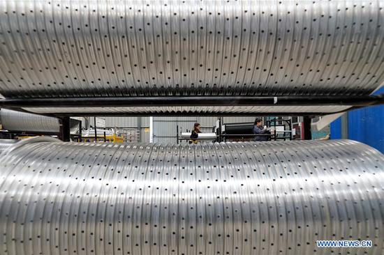 Staff members arrange the semi-finished bicycle rims at the Tangshan Jinhengtong Group in Lutai Economic Development Zone of Tangshan City, north China's Hebei Province, Oct. 14, 2020. In recent years, local authorities of Lutai Economic Development Zone in Tangshan have pushed forward the upgrading and industrial agglomeration of local bicycle components production companies. With more than 40 companies achieving a yearly revenue of about 5 billion yuan (about 745 million U.S. dollars), the bicycle component products have made their presence in both domestic and overseas market. (Xinhua/Mu Yu)