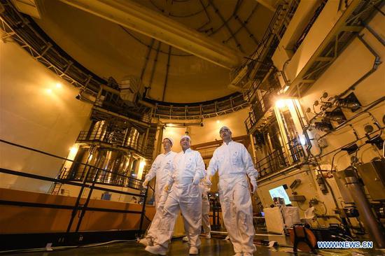 Qiao Sukai (C) and his team leave after finished their work at the Dayawan Nuclear Power Plant in Shenzhen, south China's Guangdong Province, April 12, 2019. Every 18 months, the Dayawan Nuclear Power Plant has to undergo a fuel assemblies replacement, which is one of the most important moments for the nuclear power plant. Dozens of engineers are divided into four shifts and operate the equipment day and night when the reactor is shut down. Their leader, Qiao Sukai, has been dealing with nuclear fuel since July 1993 when the nuclear fuel assembly of Dayawan Nuclear Power Plant arrived. The professional and technical maintenance team led by Qiao is responsible for the maintenance of nuclear fuel for more than half of the nuclear power units in the country. Qiao and his team have successfully operated fuel installing and uninstalling more than 170 times without making a single mistake. (Xinhua/Mao Siqian)