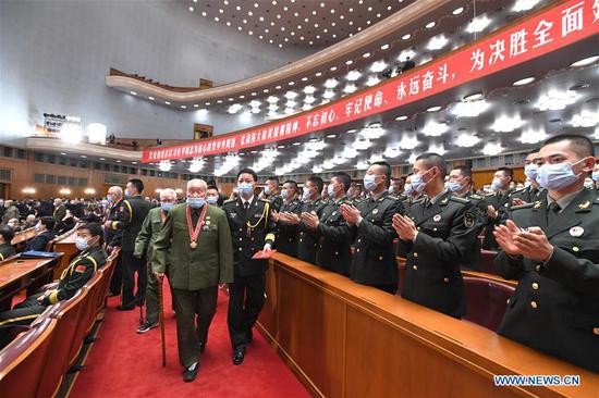 Chinese People's Volunteers (CPV) veterans enter the venue of the meeting marking the 70th anniversary of the CPV entering the Democratic People's Republic of Korea to fight in the War to Resist U.S. Aggression and Aid Korea at the Great Hall of the People in Beijing, capital of China, Oct. 23, 2020. (Xinhua/Rao Aimin)
