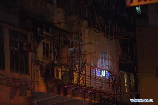 Fire fighters and police officers investigate a fire scene in Hong Kong, south China, Nov. 15, 2020. Seven people were killed and more than 10 others were injured after a fire broke out at a tenement building in Hong Kong on Sunday night, the police said. The fire, which occurred around 8 p.m. local time at the building along the Canton Road, Jordan, was extinguished about two hours later. (Xinhua/Lui Siu Wai)