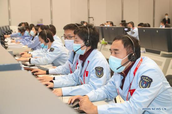 Technical personnel work at the Beijing Aerospace Control Center (BACC) in Beijing, capital of China, Nov. 29, 2020. China's Chang'e-5 probe performed braking for the second time at 20:23 p.m. Sunday (Beijing Time), according to the China National Space Administration (CNSA). After the deceleration, the probe started flying in a near circular orbit from an elliptical path around the moon, said the CNSA. (BACC/Handout via Xinhua)