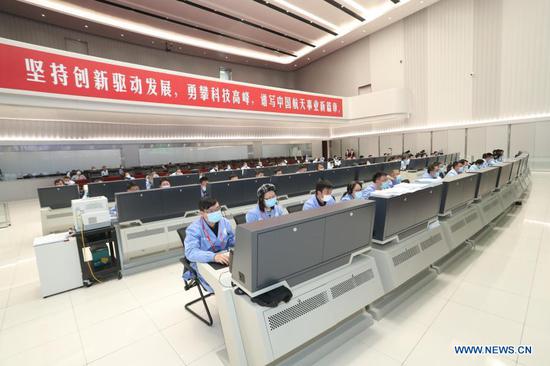  Technical personnel work at the Beijing Aerospace Control Center (BACC) in Beijing, capital of China, Nov. 29, 2020. China's Chang'e-5 probe performed braking for the second time at 20:23 p.m. Sunday (Beijing Time), according to the China National Space Administration (CNSA). After the deceleration, the probe started flying in a near circular orbit from an elliptical path around the moon, said the CNSA. (BACC/Handout via Xinhua)