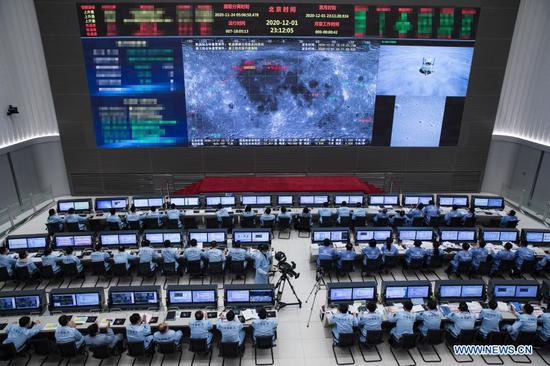 Technical personnel work at the Beijing Aerospace Control Center (BACC) in Beijing, capital of China, Dec. 1, 2020. China's Chang'e-5 spacecraft successfully landed on the near side of the moon late Tuesday and sent back images, the China National Space Administration (CNSA) announced. At 11:11 p.m., the spacecraft landed at the preselected landing area near 51.8 degrees west longitude and 43.1 degrees north latitude, said the CNSA. During the landing process, the cameras aboard the lander took images of the landing area, said the CNSA. (CNSA/Handout via Xinhua)