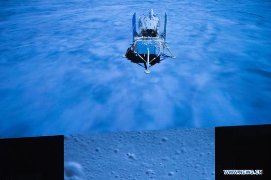 Photo taken at Beijing Aerospace Control Center (BACC) in Beijing on Dec. 1, 2020 shows the Chang'e-5 spacecraft landing on the moon. China's Chang'e-5 spacecraft successfully landed on the near side of the moon late Tuesday and sent back images, the China National Space Administration (CNSA) announced. At 11:11 p.m., the spacecraft landed at the preselected landing area near 51.8 degrees west longitude and 43.1 degrees north latitude, said the CNSA. During the landing process, the cameras aboard the lander took images of the landing area, said the CNSA. (Xinhua/Jin Liwang)