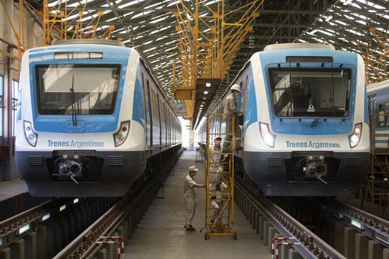 Chinese engineers and technicians with CRRC Qingdao Sifang Co., Ltd., together with their Argentine colleagues, inspect a train in Llavallol, some 33 km south of Buenos Aires, Argentina, Nov. 16, 2020. (Photo by Martin Zabala/Xinhua)