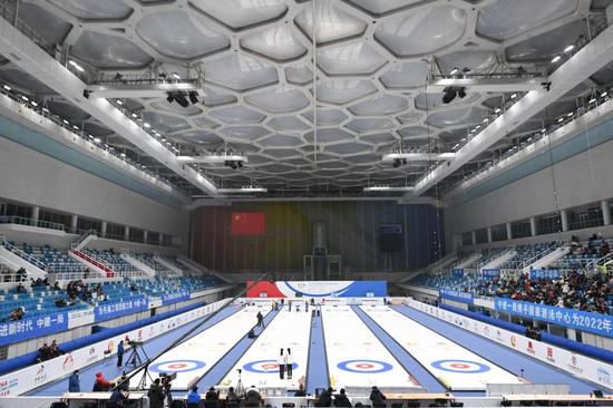 Spectators watch the 2019 China Junior Curling Open girls' final match at the National Aquatics Center (the Water Cube) in Beijing, capital of China, Dec. 8, 2019. (Xinhua/Ju Huanzong)