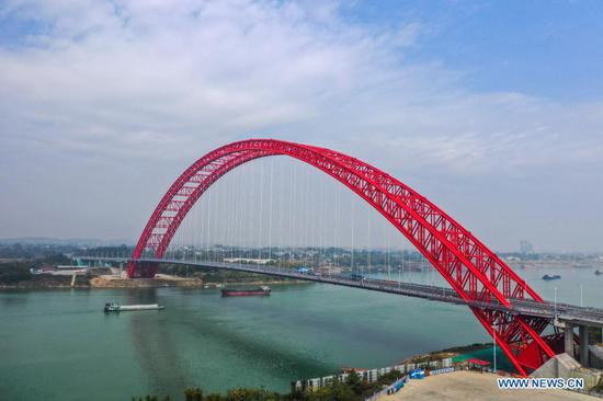 Aerial photo taken on Dec. 28, 2020 shows a view of the Third Pingnan Bridge in Pingnan County, Guigang City of south China's Guangxi Zhuang Autonomous Region. With a length of 1,035 meters, the bridge, whose construction started from June of 2018, was completed and opened to traffic on Monday. (Xinhua/Cao Yiming)