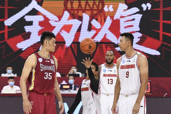 One-armed boy Zhang Jiacheng, who became an internet sensation in China after showing off his basketball skills, participates in the Chinese Basketball Association (CBA) league's resumption ceremony on June 20, 2020. (Xinhua/Liang Xu)