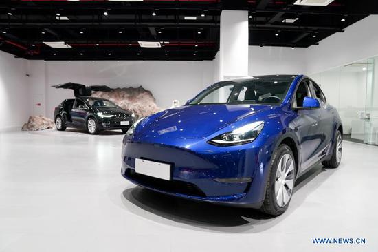 A Tesla Model Y vehicle is pictured at a Tesla Center in east China's Shanghai, Jan. 18, 2021. U.S. electric carmaker Tesla Inc. on Monday began Shanghai deliveries of its built-in-China Model Y. On Jan. 7, 2020, Tesla launched the project to manufacture Model Y vehicles in its Shanghai Gigafactory, its first overseas plant outside the United States. The China-made model went on sale on Jan. 1. (Xinhua/Ding Ting)