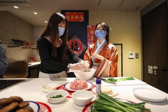 Chinese students make dumplings during an online Spring Festival Gala in Tokyo, Japan, Feb. 6, 2021, to celebrate the Chinese New Year. (Xinhua/Du Xiaoyi)