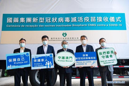 Guests pose for a group photo at a handover ceremony of the second batch of mainland-made COVID-19 vaccines in Macao, south China, Feb. 28, 2021. The second batch of mainland-made COVID-19 vaccines were delivered to the Macao Special Administrative Region on Sunday. The first batch of mainland-made vaccines were delivered to Macao on Feb. 6. Inoculation started on Feb. 9. (Xinhua/Cheong Kam Ka)