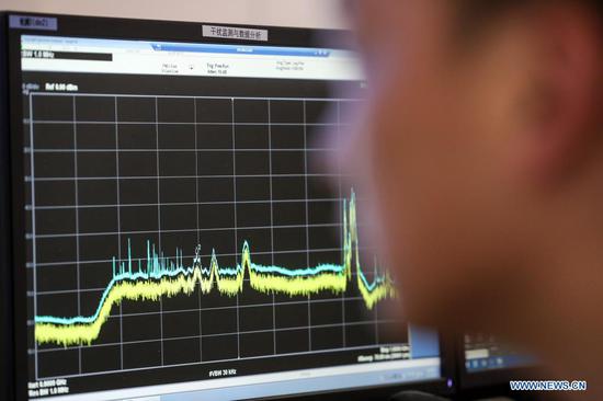 A staff member works at the control room of China's Five-hundred-meter Aperture Spherical radio Telescope (FAST) in southwest China's Guizhou Province, March 27, 2021. FAST has identified over 300 pulsars so far. Located in a naturally deep and round karst depression in southwest China's Guizhou Province, it officially began operating on Jan. 11, 2020. (Xinhua/Ou Dongqu)