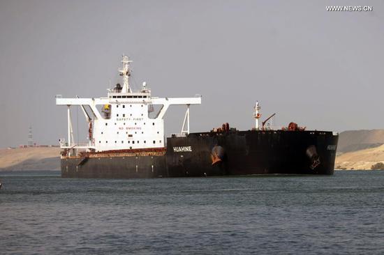 Photo taken on March 30, 2021 shows a ship sailing on the Suez Canal, Egypt. At least 113 container ships have passed through the Suez Canal that was blocked by a massive cargo container, chairman of the Suez Canal Authority (SCA) Osama Rabie said on Tuesday. (Xinhua/Ahmed Gomaa)