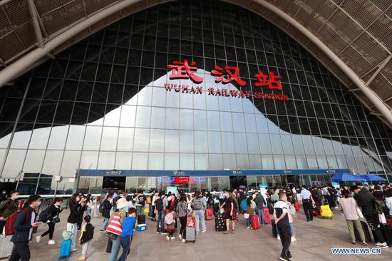 Passengers walk into Wuhan Railway Station in Wuhan, capital of central China's Hubei Province, May 5, 2021. During the five-day Labor Day holiday, about 4.03 million passenger trips were made via 117 railway stations administered by China Railway Wuhan Bureau Group Co., Ltd. (Photo by Zhao Jun/Xinhua)