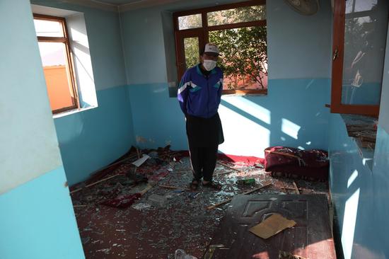 An Afghan man stands in a damaged room near the site of a car bomb attack in Kabul, capital of Afghanistan, May 9, 2021. (Photo by Rahmatullah Alizadah/Xinhua)