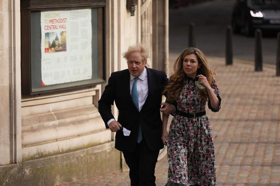 Britain's Prime Minister Boris Johnson and his fiancee Carrie Symonds arrive to vote for the local elections at a polling station in London, Britain, May 6, 2021. (Photo by Tim Ireland/Xinhua)