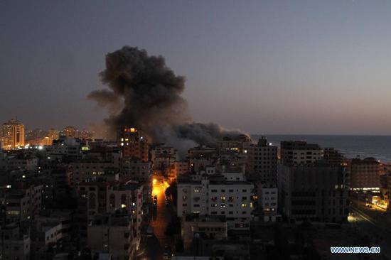 Photo taken on May 11, 2021 shows explosions following Israeli air strikes in Gaza City. Israeli military chief Aviv Kochavi decided on Tuesday to extend Israel's offensive in the Gaza Strip "with no time limit" amid the tensions with Hamas, a Palestinian movement that runs the strip. Three women in Israel and 28 people in Gaza Strip have been reportedly killed since Monday in the worst flare-up of Israeli-Palestinian violence since Israel's major military assault in Gaza in 2014. (Photo by Rizek Abdeljawad/Xinhua)