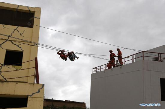 Armed police take part in a rope rescue training at the National Urban Search and Rescue (USAR) Training Center of Lanzhou in Yuzhong County of Lanzhou, capital of northwest China's Gansu Province, May 10, 2021. The National USAR Training Center of Lanzhou has a rescue team made up of armed police, medical staff and members of the China Earthquake Administration. The center, which has multi-functional professional training fields, facilities and equipment, can train professional rescue teams to deal with complicated circumstances. Meanwhile, as a state-level popular science education base for earthquake prevention and disaster reduction, it has opened various forms of popular science education classes. (Xinhua/Fan Peishen)