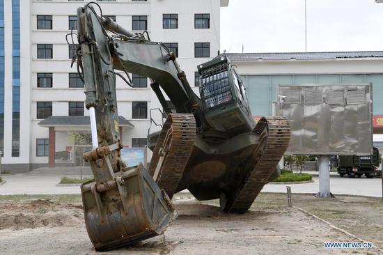 An armed police officer takes part in an excavator balance-driving training at the National Urban Search and Rescue (USAR) Training Center of Lanzhou in Yuzhong County of Lanzhou, capital of northwest China's Gansu Province, May 10, 2021. The National USAR Training Center of Lanzhou has a rescue team made up of armed police, medical staff and members of the China Earthquake Administration. The center, which has multi-functional professional training fields, facilities and equipment, can train professional rescue teams to deal with complicated circumstances. Meanwhile, as a state-level popular science education base for earthquake prevention and disaster reduction, it has opened various forms of popular science education classes. (Xinhua/Fan Peishen)