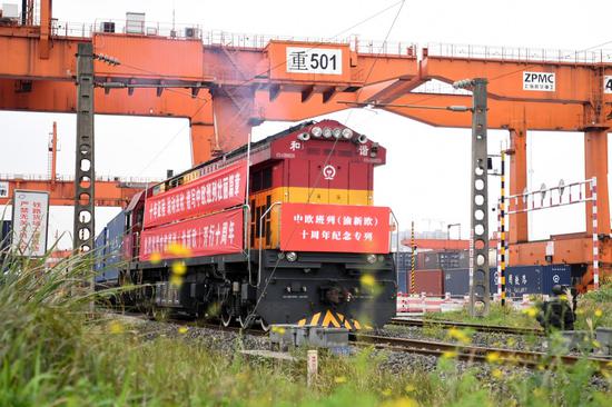 A Yuxin'ou (Chongqing-Xinjiang-Europe) China-Europe freight train leaves the Tuanjie Village Station of southwest China's Chongqing Municipality, March 19, 2021. (Xinhua/Tang Yi)