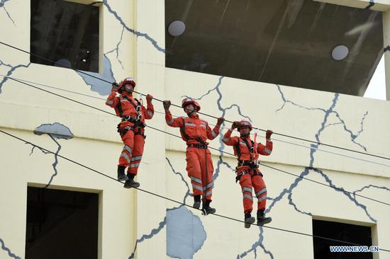 Armed police take part in a rope rescue training at the National Urban Search and Rescue (USAR) Training Center of Lanzhou in Yuzhong County of Lanzhou, capital of northwest China's Gansu Province, May 10, 2021. The National USAR Training Center of Lanzhou has a rescue team made up of armed police, medical staff and members of the China Earthquake Administration. The center, which has multi-functional professional training fields, facilities and equipment, can train professional rescue teams to deal with complicated circumstances. Meanwhile, as a state-level popular science education base for earthquake prevention and disaster reduction, it has opened various forms of popular science education classes. (Xinhua/Fan Peishen)