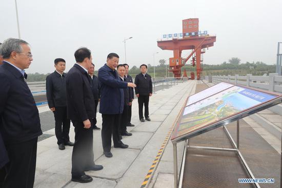 Chinese President Xi Jinping, also general secretary of the Communist Party of China Central Committee and chairman of the Central Military Commission, inspects the Taocha Canal Head and listens to introductions to the construction, management and operation of the middle route of the South-to-North Water Diversion Project, and the ecological conservation of the water source region in Xichuan County, Nanyang, central China's Henan Province, May 13, 2021. (Xinhua/Wang Ye)