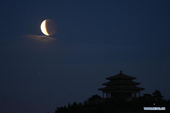 Lunar eclipse is seen above Beijing, capital of China, May 26, 2021. (Xinhua/Ju Huanzong)