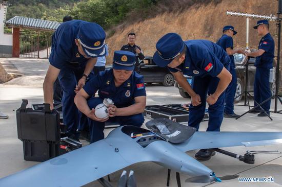 A drone is prepared to monitor the migrating wild Asian elephants in Eshan County, Yuxi City, southwest China's Yunnan Province, May 29, 2021. Authorities are tracking 15 wild Asian elephants in southwest China's Yunnan Province as the herd migrates northward. The elephants are now wandering in the county of Eshan, following a long journey from the province's southmost prefecture starting from April 16. They are currently less than 50 km away from the provincial capital Kunming, the provincial forestry and grassland administration said. Monitoring images show that the herd includes six female adult elephants, three male adults, three sub-adults, and three cubs. (Xinhua/Hu Chao)