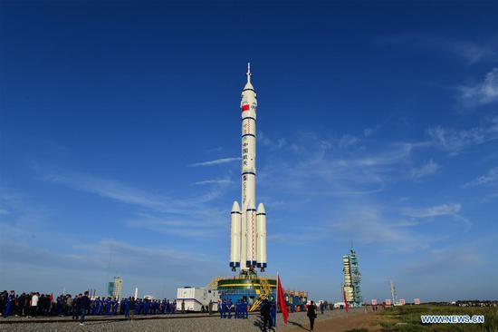 The combination of the Shenzhou-12 manned spaceship and a Long March-2F carrier rocket is being transferred to the launching area of Jiuquan Satellite Launch Center in northwest China, June 9, 2021. The combination of the Shenzhou-12 manned spaceship and a Long March-2F carrier rocket has been transferred to the launching area, the China Manned Space Agency (CMSA) said Wednesday. The facilities and equipment at the launch site are in good condition, and various pre-launch function checks and joint tests will be carried out as planned, said the CMSA. (Photo by Wang Jiangbo/Xinhua)