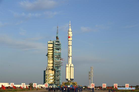 Photo shows the combination of the Shenzhou-12 manned spaceship and a Long March-2F carrier rocket after it was transferred to the launching area of Jiuquan Satellite Launch Center in northwest China, June 9, 2021. The combination of the Shenzhou-12 manned spaceship and a Long March-2F carrier rocket has been transferred to the launching area, the China Manned Space Agency (CMSA) said Wednesday. The facilities and equipment at the launch site are in good condition, and various pre-launch function checks and joint tests will be carried out as planned, said the CMSA. (Photo by Wang Jiangbo/Xinhua)