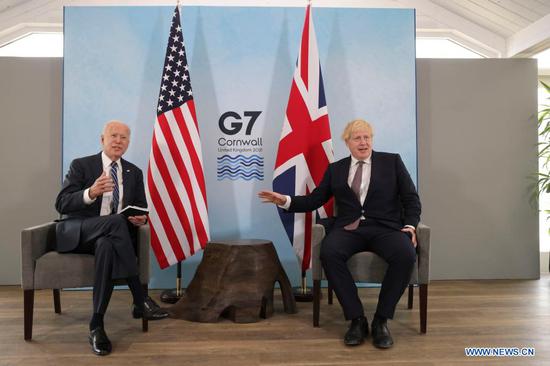 British Prime Minister Boris Johnson (R) meets with U.S. President Joe Biden in Carbis Bay, Cornwall, Britain, on June 10, 2021. Boris Johnson and Joe Biden on Thursday agreed to work to resume travel between the two countries and signed a new Atlantic Charter, as they met ahead of the Group of Seven (G7) summit. (Andrew Parsons/No 10 Downing Street/Handout via Xinhua)