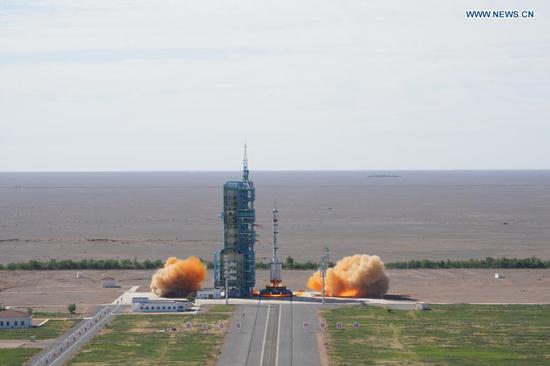 The crewed spacecraft Shenzhou-12, atop a Long March-2F carrier rocket, is launched from the Jiuquan Satellite Launch Center in northwest China's Gobi Desert, June 17, 2021. (Xinhua/Li Gang)